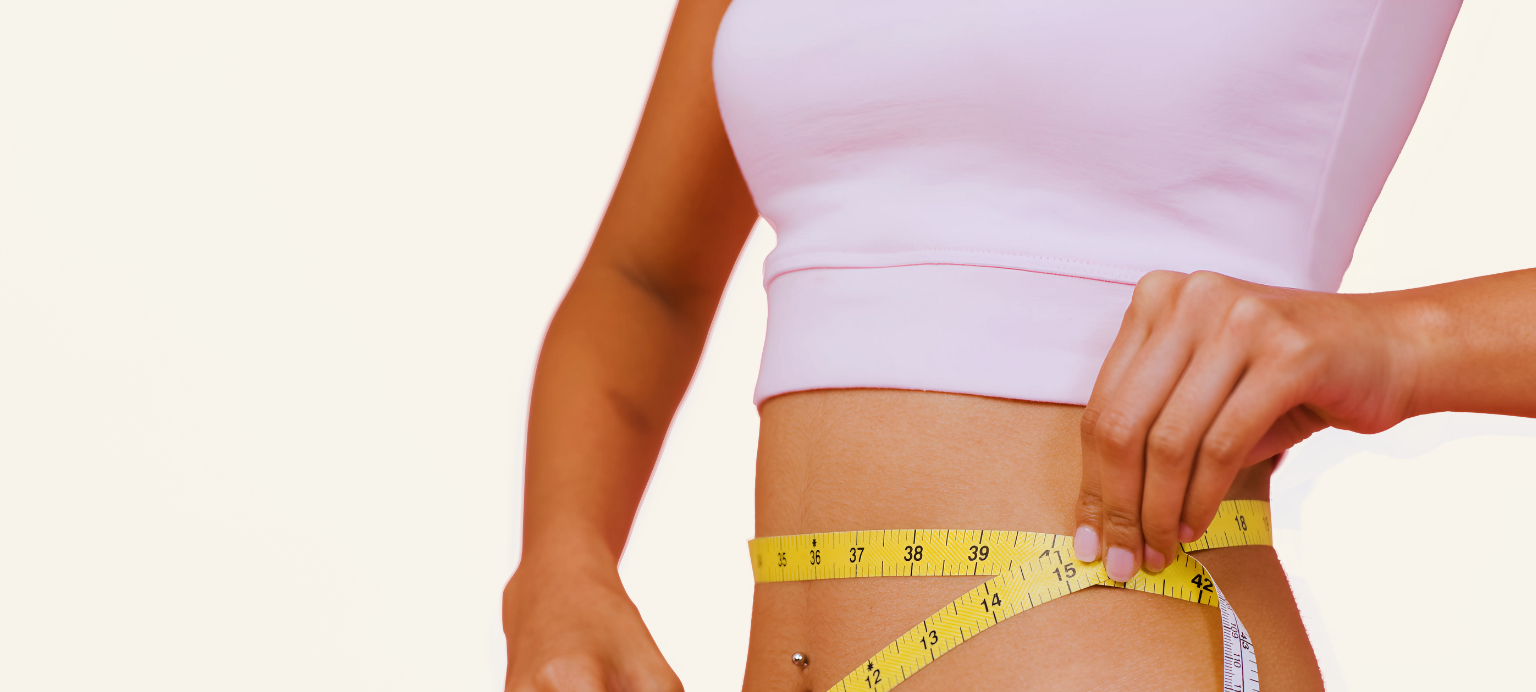 Woman measuring waist with yellow tape measure