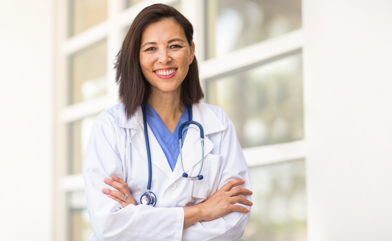 Mature doctor looking at screen.